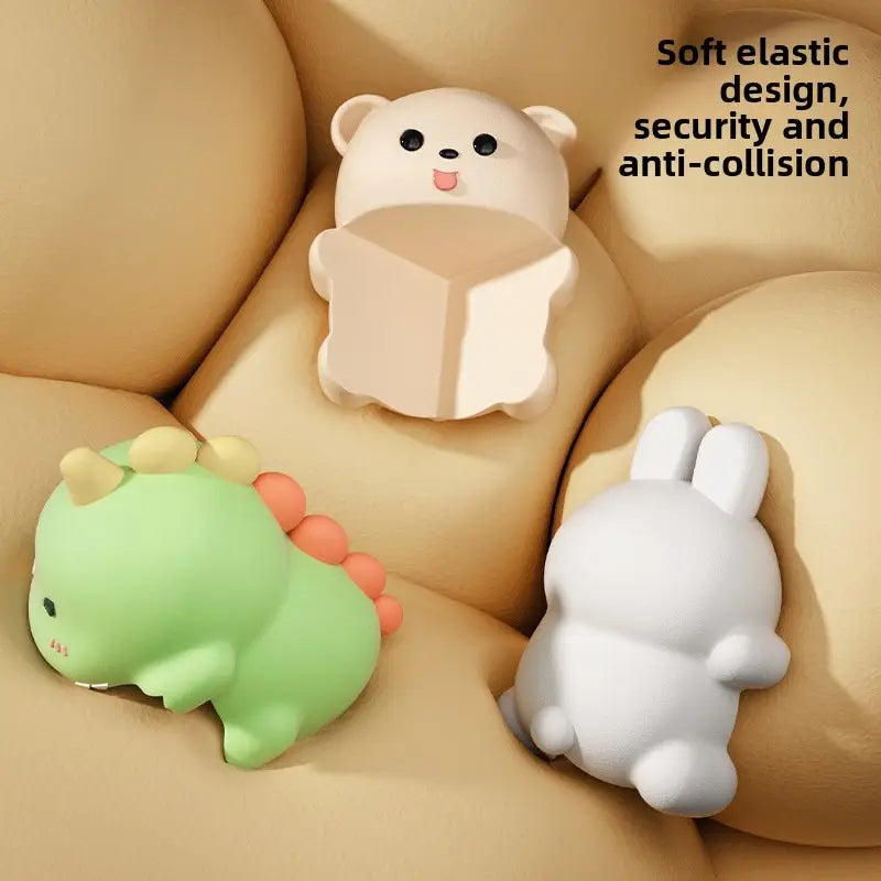 Dinosaur, bear, and rabbit corner protectors on a sofa