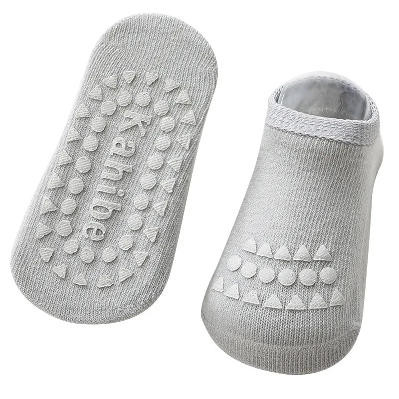 Gray anti-slip crawling knee pad and sock set, flat lay