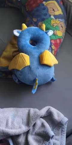 Real customer photo — dragon character PumPom Kids cushion